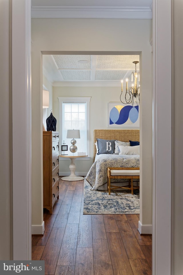 bedroom with dark wood-type flooring and an inviting chandelier