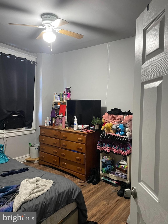 bedroom featuring hardwood / wood-style flooring and ceiling fan