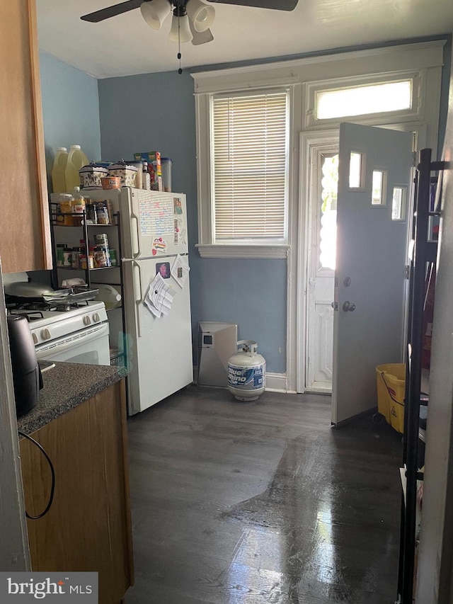 kitchen with ceiling fan, dark hardwood / wood-style floors, and white appliances