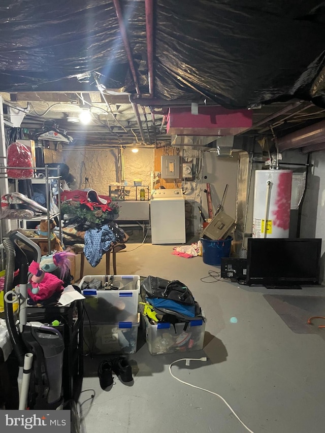 basement featuring electric panel, gas water heater, and washer / dryer