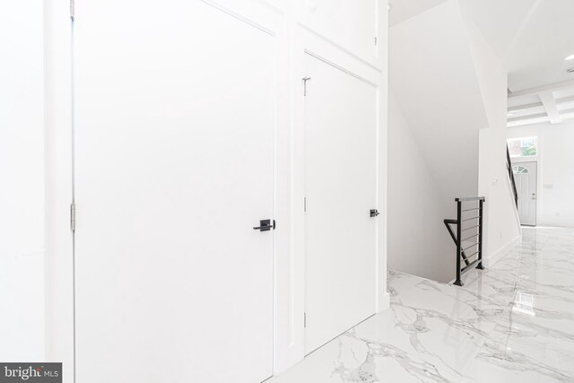 hall featuring beam ceiling and coffered ceiling