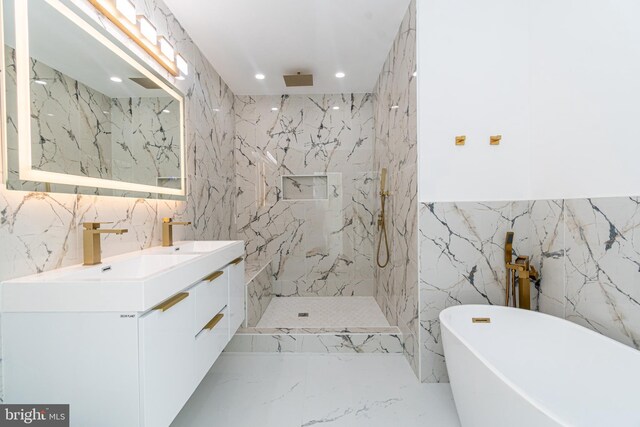 bathroom featuring vanity and shower with separate bathtub