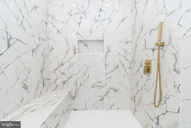 bathroom with tiled shower