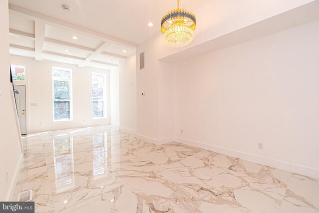 empty room featuring beamed ceiling, a notable chandelier, and coffered ceiling