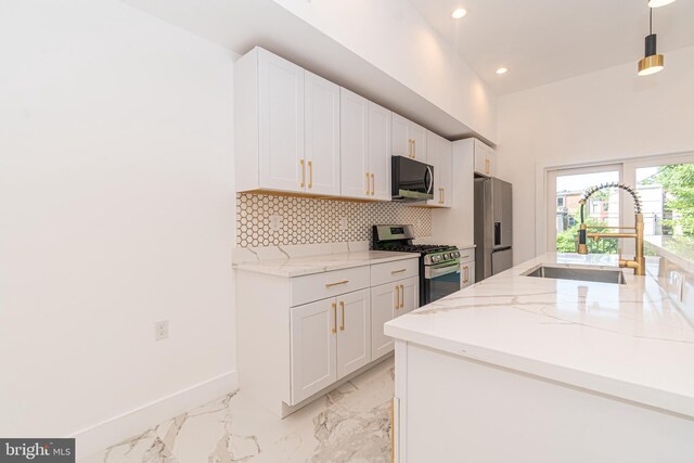 kitchen featuring white cabinets, hanging light fixtures, sink, and appliances with stainless steel finishes