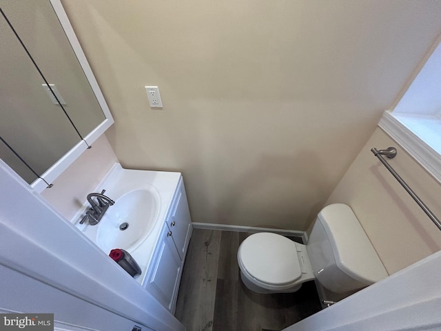 bathroom featuring hardwood / wood-style floors, vanity, and toilet