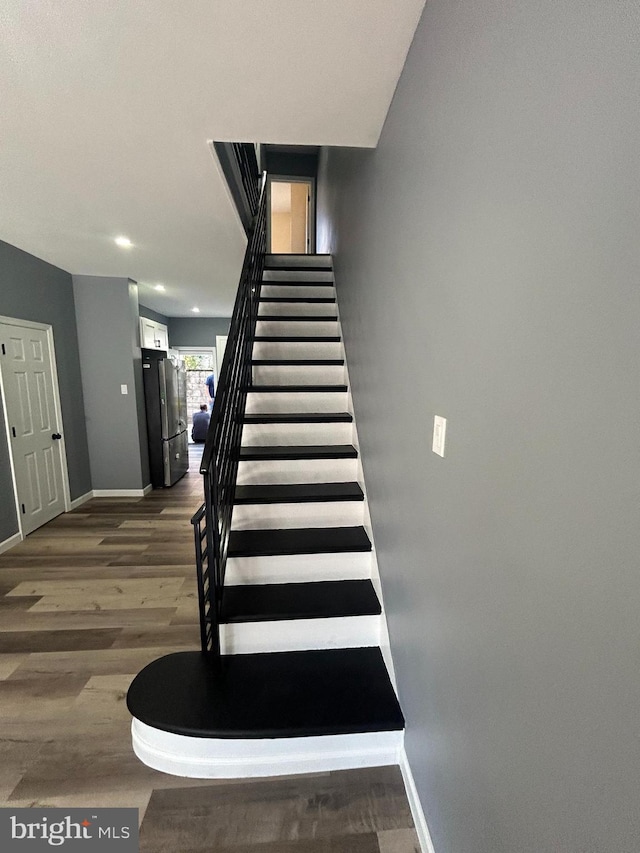 stairway featuring hardwood / wood-style floors