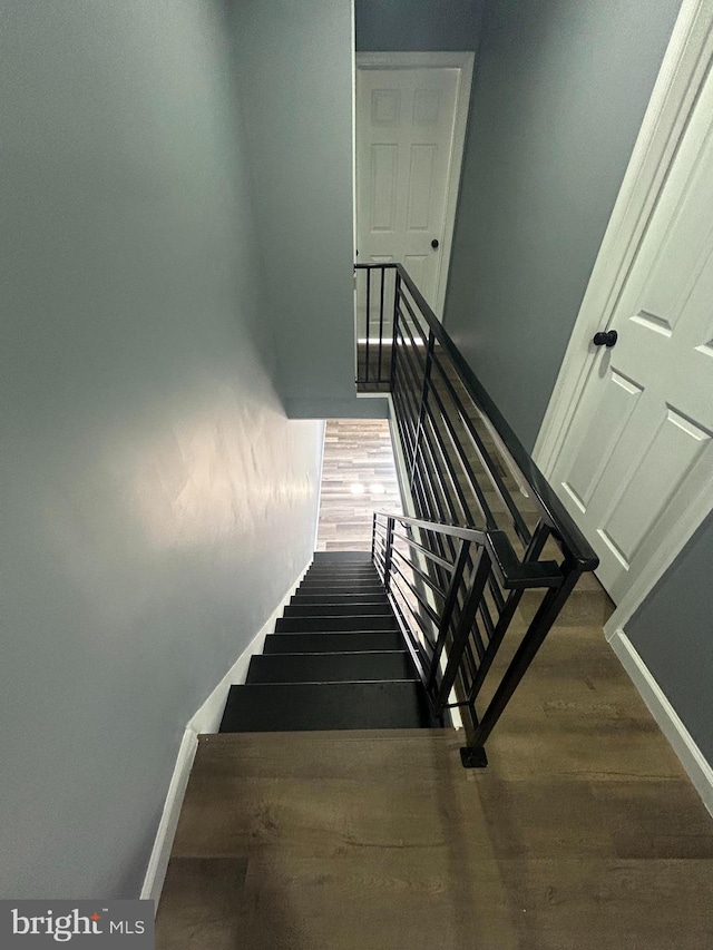 stairs featuring wood-type flooring