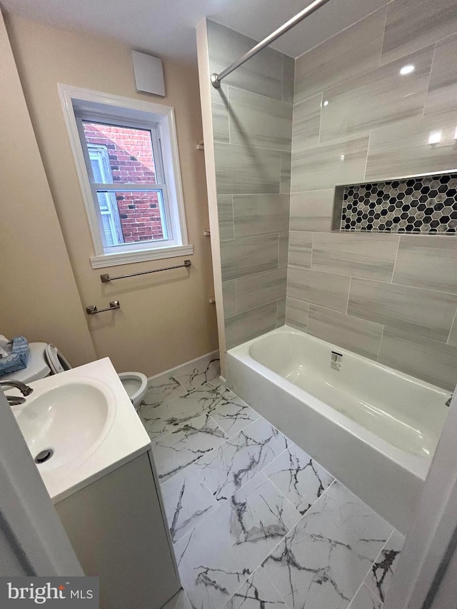 full bathroom with vanity, tiled shower / bath combo, and toilet