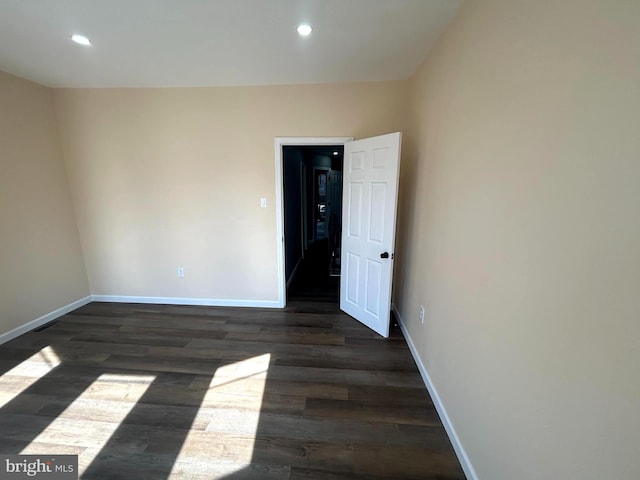 unfurnished room featuring dark wood-type flooring