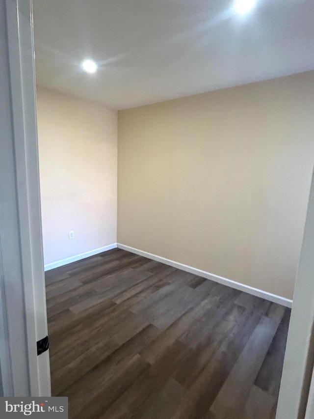 spare room featuring dark wood-type flooring