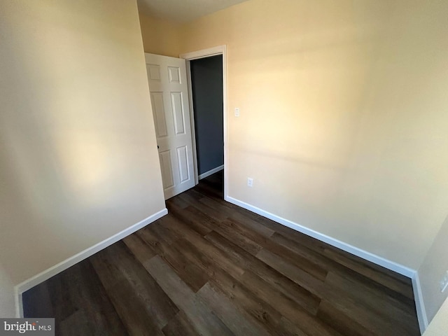 spare room with dark hardwood / wood-style floors