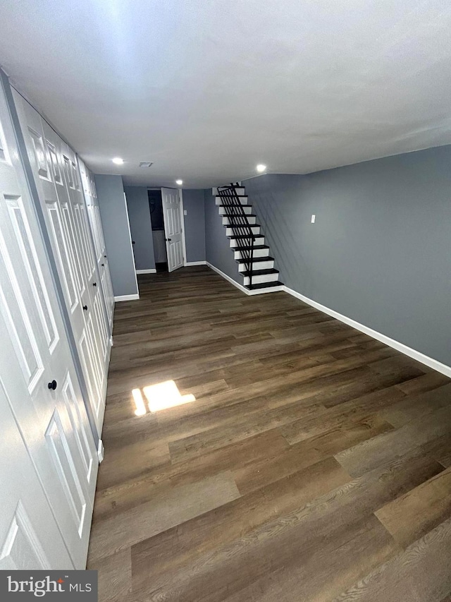 basement featuring dark hardwood / wood-style flooring