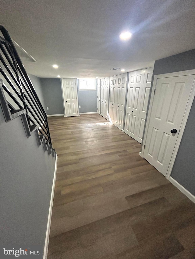 corridor with hardwood / wood-style floors