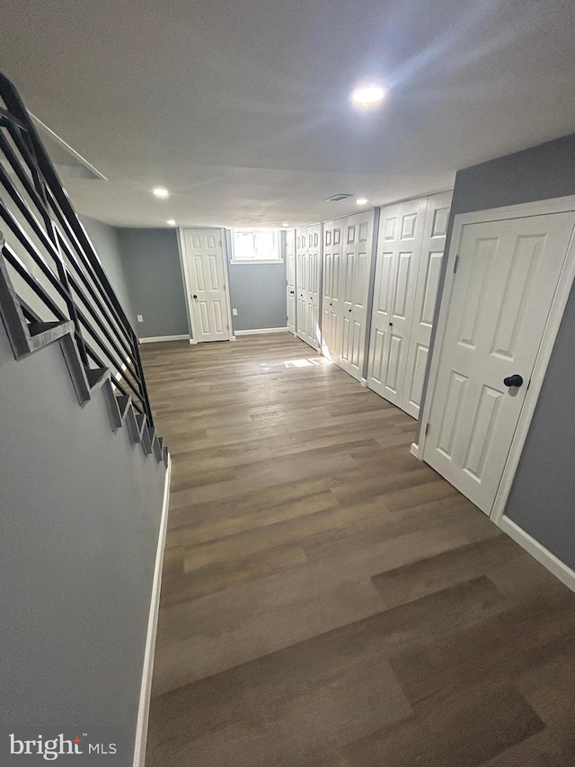 corridor with hardwood / wood-style floors