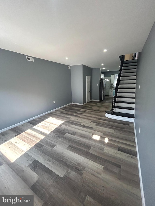 empty room with dark hardwood / wood-style flooring