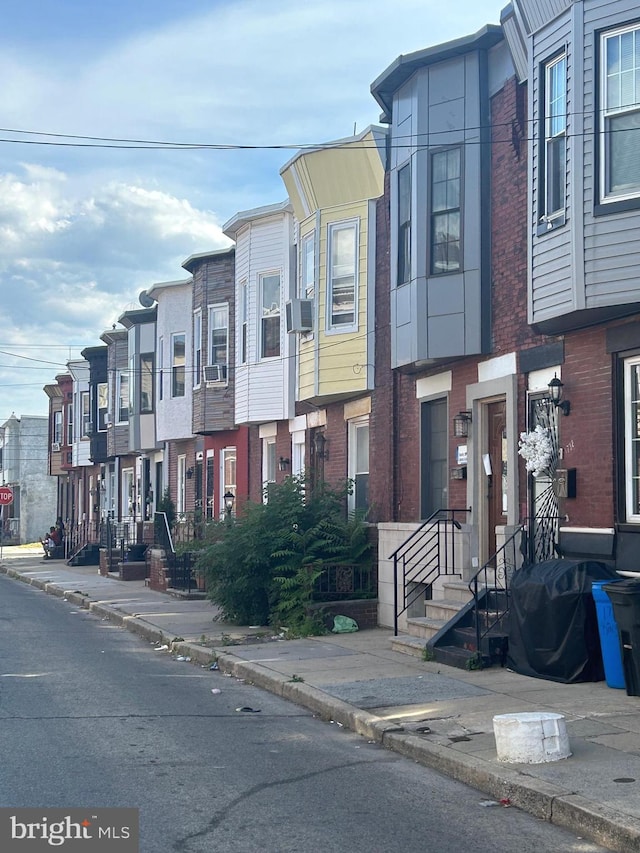 multi unit property featuring cooling unit and a balcony