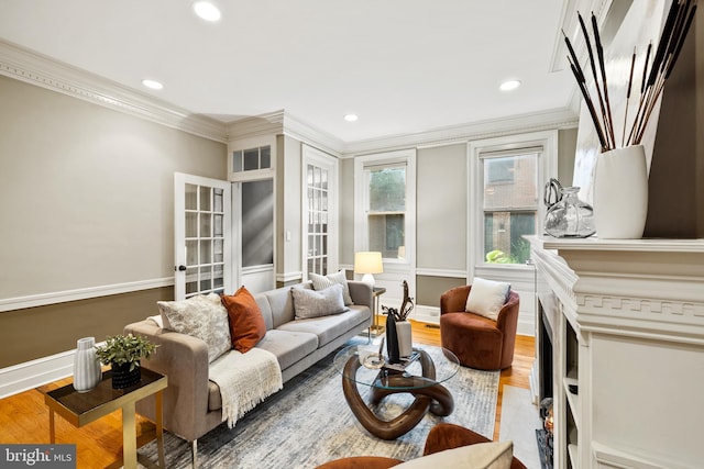 living room with ornamental molding and hardwood / wood-style flooring