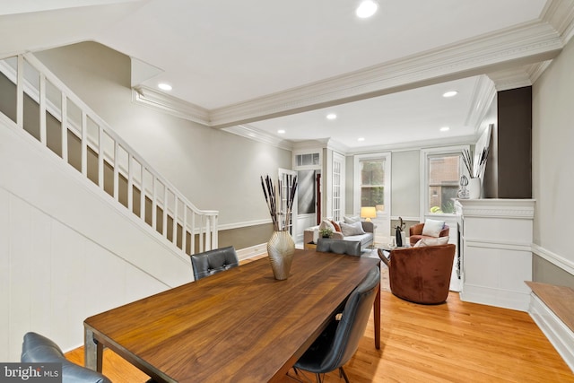 dining room featuring crown molding and light hardwood / wood-style floors