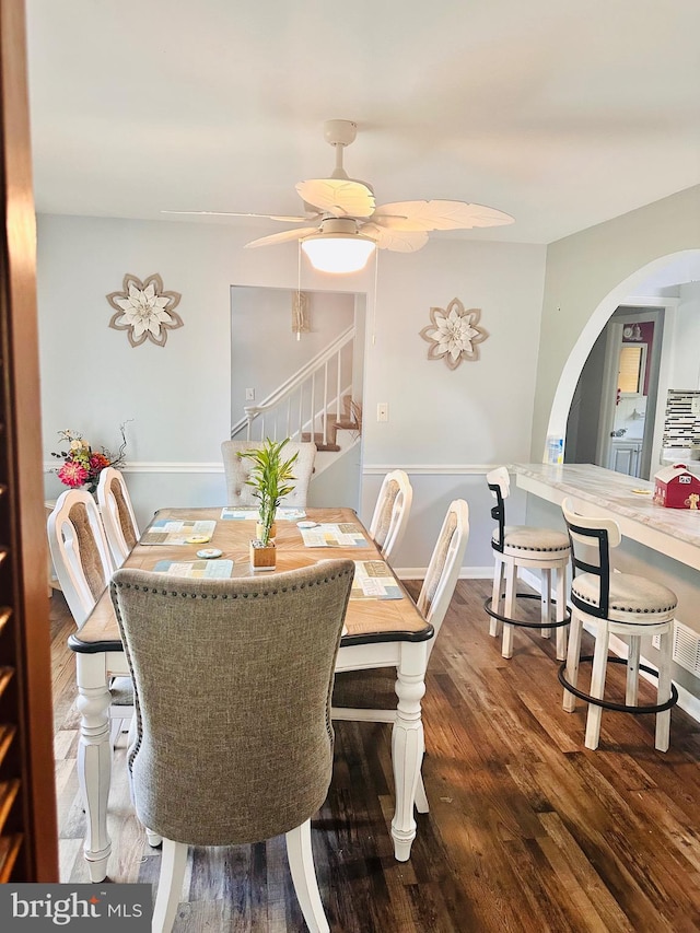 dining space with dark hardwood / wood-style flooring and ceiling fan