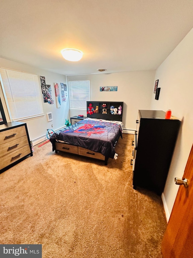 bedroom with dark carpet and baseboard heating