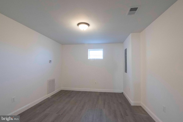 spare room with dark wood-type flooring