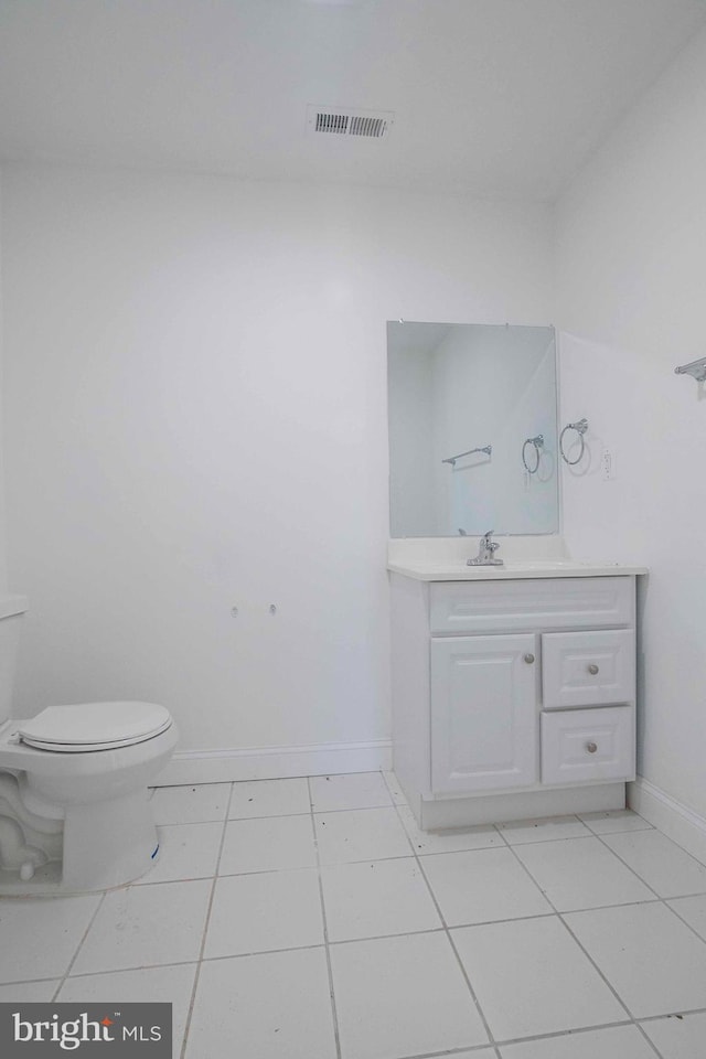 bathroom featuring tile patterned floors, vanity, and toilet