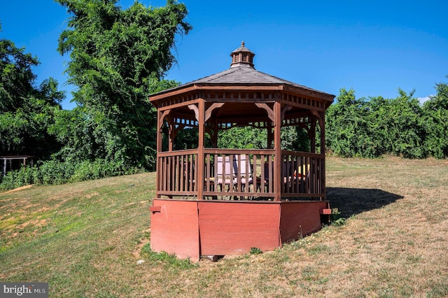 exterior space with a gazebo and a lawn