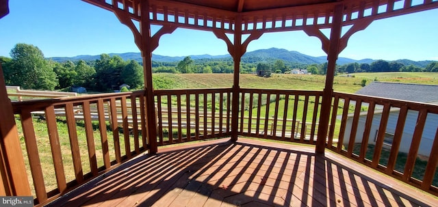 wooden terrace with a mountain view and a rural view