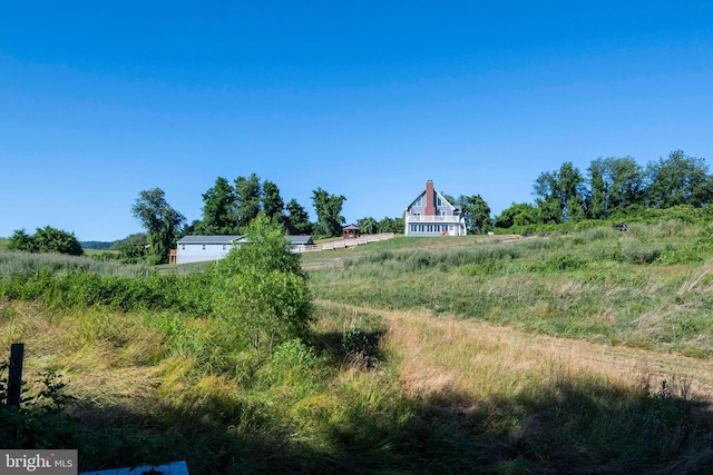 view of yard with a rural view