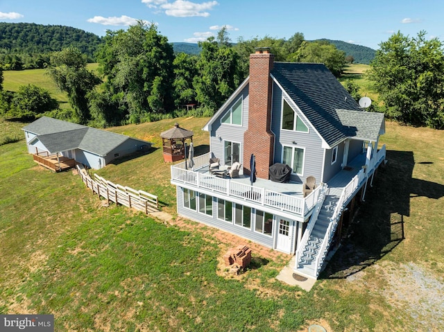 rear view of property featuring a deck