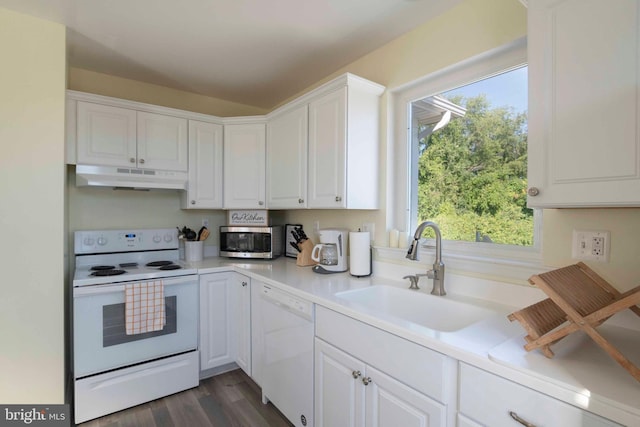 kitchen featuring white cabinetry, sink, dark hardwood / wood-style floors, and white appliances