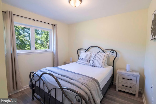 bedroom with dark wood-type flooring