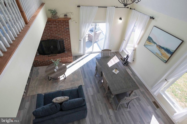 living room with hardwood / wood-style floors and a brick fireplace