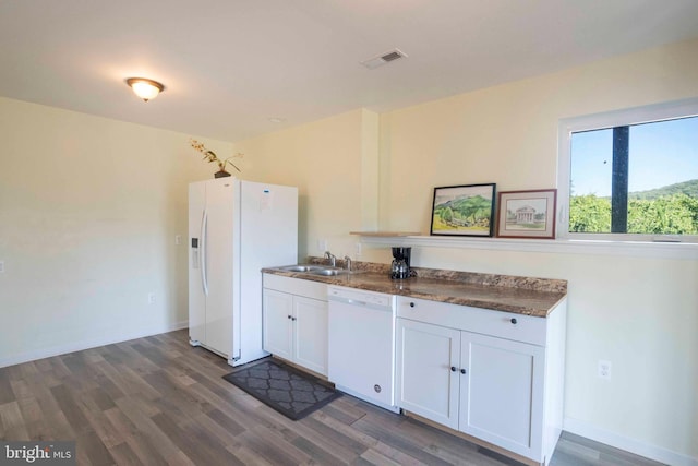 kitchen featuring white cabinets, dark hardwood / wood-style flooring, white appliances, and sink