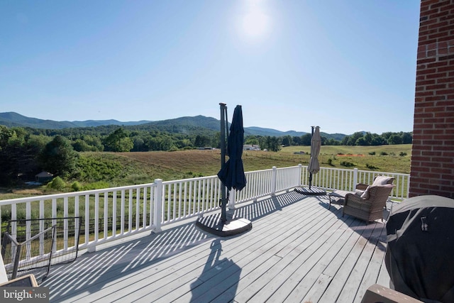 wooden deck featuring a mountain view, a rural view, and grilling area