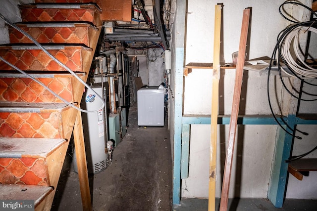 utility room with water heater and washer / dryer