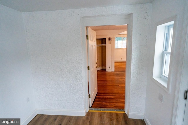 hallway with dark hardwood / wood-style floors