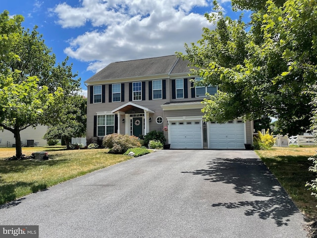 view of front of property featuring a front yard and a garage