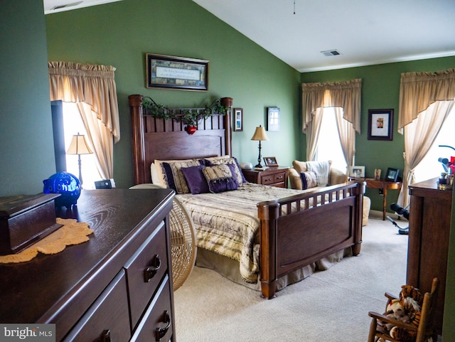 bedroom featuring light colored carpet, vaulted ceiling, and multiple windows