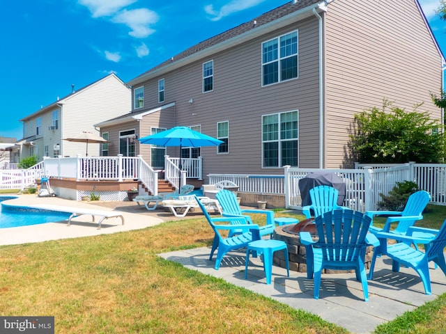 back of property featuring a swimming pool side deck and a yard