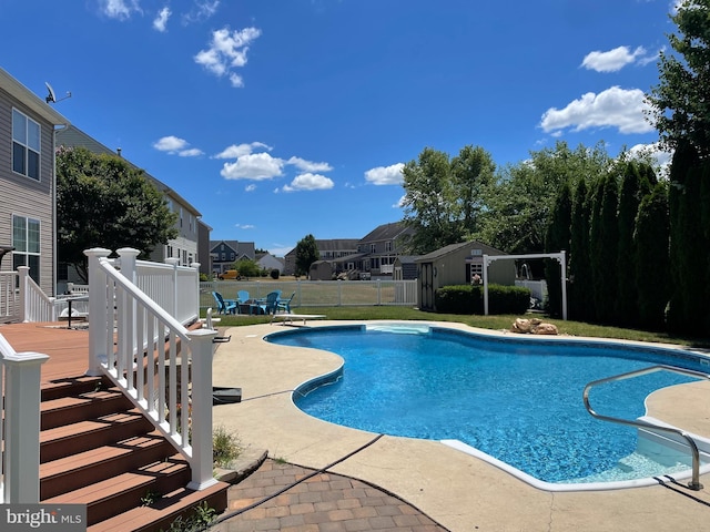 view of swimming pool with a deck and a patio area