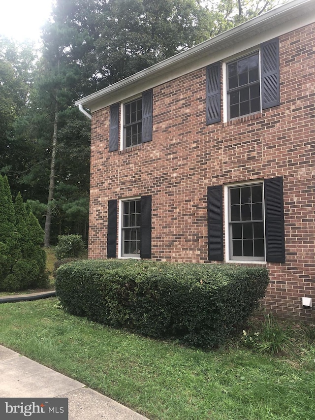 view of side of home featuring a yard