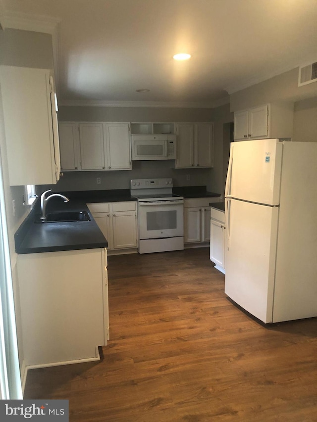 kitchen featuring white cabinetry, sink, dark hardwood / wood-style floors, and white appliances