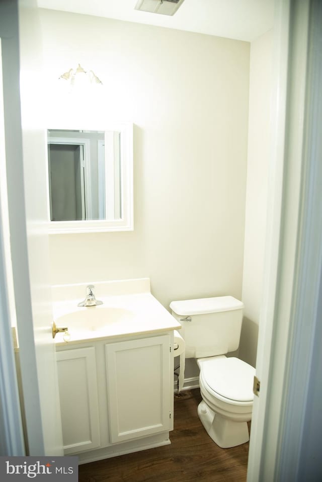 bathroom featuring vanity, toilet, and wood-type flooring