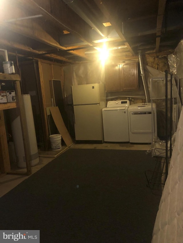 basement featuring white refrigerator and separate washer and dryer