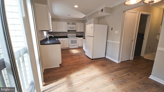 kitchen featuring dark hardwood / wood-style flooring, white appliances, crown molding, sink, and white cabinets