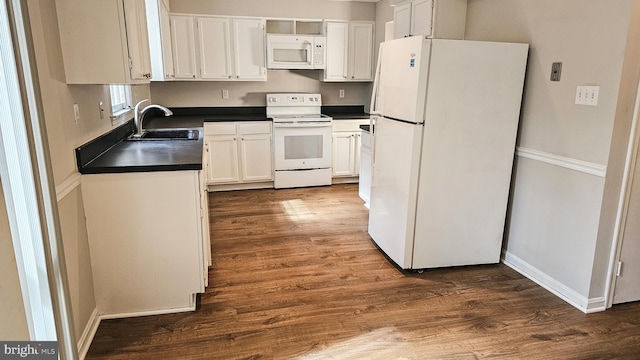 kitchen featuring dark hardwood / wood-style floors, white cabinetry, white appliances, and sink