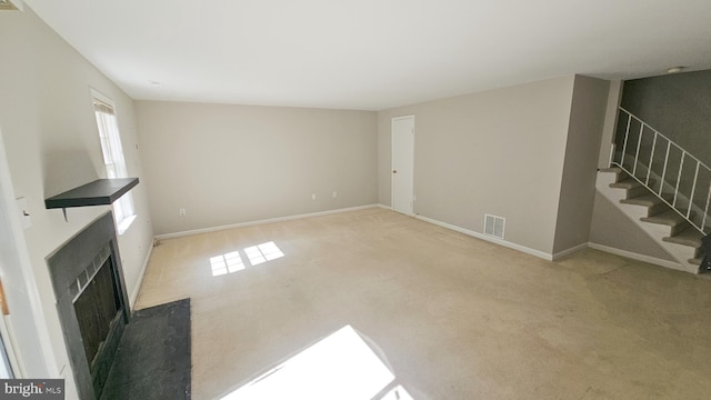 unfurnished living room with light carpet