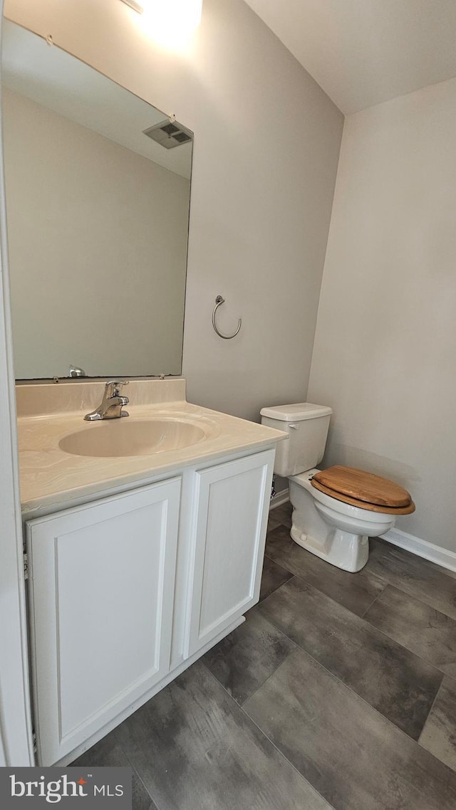 bathroom featuring vanity and toilet